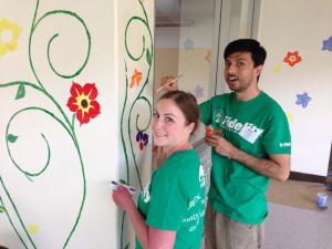 Fidelity volunteers painting murals at Elm Street School in Nashua